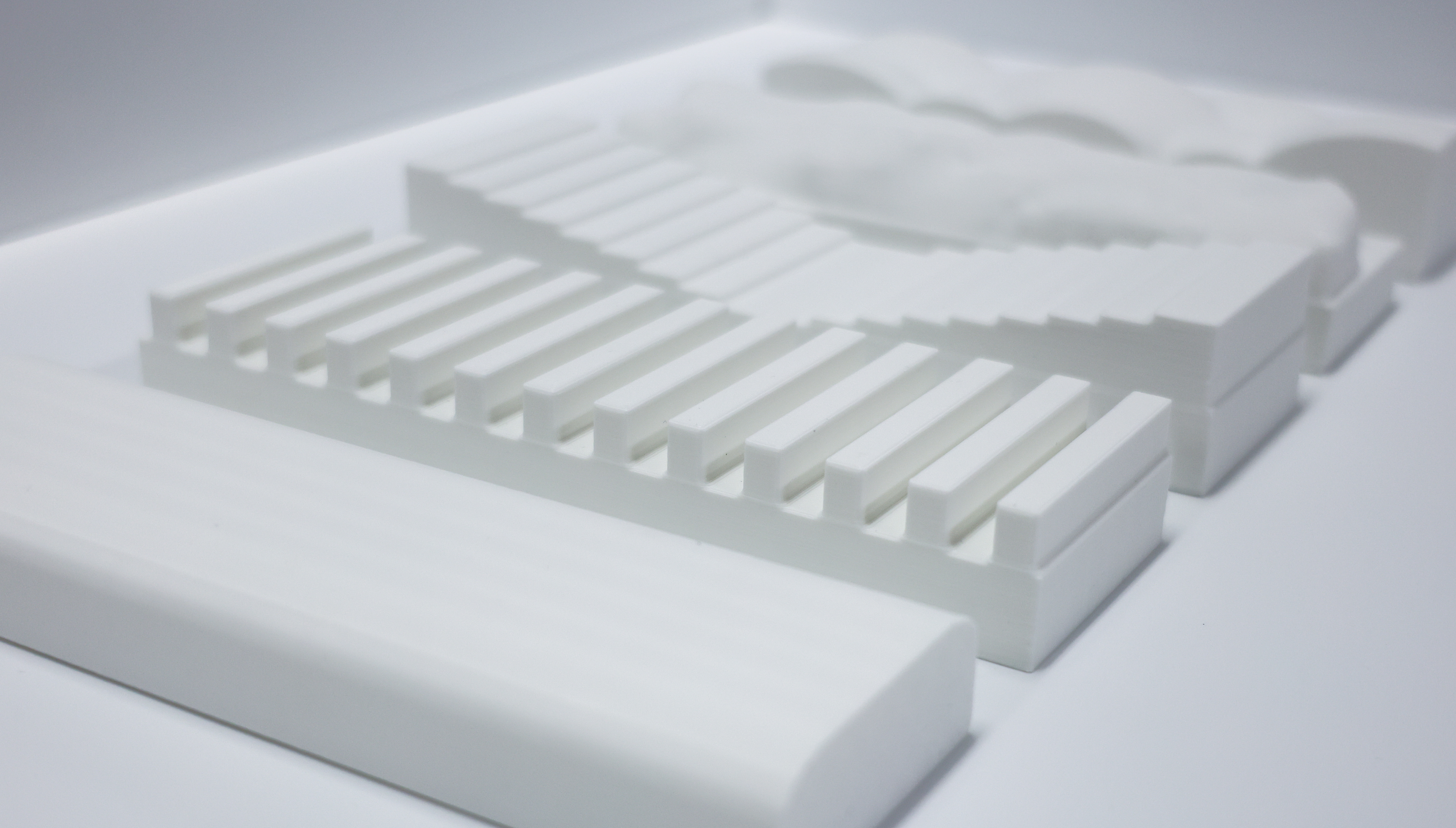 Physical booklet showing QR codes next to digital screen